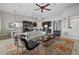 Spacious living area featuring elegant lighting and hardwood floors, leading into an open kitchen at 3808 Eastham Ln, Bradenton, FL 34211