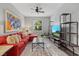 Stylish living room featuring a red sectional sofa, modern decor, and natural light at 3808 Eastham Ln, Bradenton, FL 34211