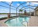 Sparkling pool and spa in a screened lanai, offering a tranquil escape with a beautiful water view at 3808 Eastham Ln, Bradenton, FL 34211