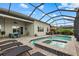 Resort-style pool with a spa and screened enclosure, surrounded by comfortable seating and lush landscaping at 3808 Eastham Ln, Bradenton, FL 34211