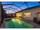 Beautiful pool and spa in screened enclosure, with outdoor kitchen and living area, extending from the home at 3808 Eastham Ln, Bradenton, FL 34211
