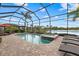 Inviting pool and spa with a screened enclosure, comfortable lounge chairs, and a scenic lake view at 3808 Eastham Ln, Bradenton, FL 34211