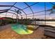 Inviting screened pool area with a relaxing spa and outdoor seating, perfect for entertaining near the lake at 3808 Eastham Ln, Bradenton, FL 34211