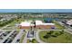 Aerial view of the community school with parking and water feature at 3808 Eastham Ln, Bradenton, FL 34211