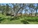 Expansive backyard with mature trees offering shade, well-maintained lawn and a serene view of the surrounding landscape at 3984 Lyndhurst Ct, Sarasota, FL 34235
