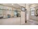 Wet bar includes glass shelving, tile countertops, and a mirrored backsplash at 3984 Lyndhurst Ct, Sarasota, FL 34235