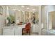 Bright bathroom with a double vanity, ample counter space, large mirror, and well-lit makeup area at 3984 Lyndhurst Ct, Sarasota, FL 34235