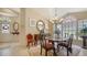 Formal dining room with chandelier, decorative mirror, and neutral flooring at 3984 Lyndhurst Ct, Sarasota, FL 34235