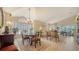 Elegant dining room with a large window, chandelier, and a formal dining table perfect for entertaining guests at 3984 Lyndhurst Ct, Sarasota, FL 34235