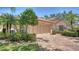 Charming single-story home with a well-manicured lawn, mature trees, and a brick driveway leading to a two-car garage at 3984 Lyndhurst Ct, Sarasota, FL 34235