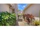 Side yard walkway, featuring mature plants and landscaping at 3984 Lyndhurst Ct, Sarasota, FL 34235
