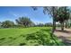 Beautiful view of the lush green golf course with mature trees on a clear day, perfect for avid golfers at 3984 Lyndhurst Ct, Sarasota, FL 34235