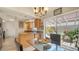 Cozy eat-in kitchen with updated cabinetry, granite countertops, and access to an outdoor courtyard with tropical plants at 3984 Lyndhurst Ct, Sarasota, FL 34235