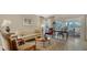 Bright living room features neutral decor, stylish furniture, and sliding doors to the lanai at 3984 Lyndhurst Ct, Sarasota, FL 34235