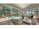 Inviting screened-in patio with a private pool, comfortable seating, and lush landscaping for outdoor relaxation at 3984 Lyndhurst Ct, Sarasota, FL 34235