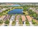 A panoramic aerial view of homes nestled around a serene lake, with lush greenery and community amenities at 4016 Azurite Way, Bradenton, FL 34211