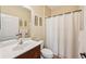 Standard bathroom features a single sink vanity, toilet, and shower/tub combination with a white shower curtain at 4016 Azurite Way, Bradenton, FL 34211