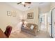 Bedroom with neutral walls, carpet and a ceiling fan, includes a desk area and a comfortable couch at 4016 Azurite Way, Bradenton, FL 34211