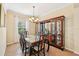 Elegant dining room featuring a large china cabinet and a modern chandelier at 4016 Azurite Way, Bradenton, FL 34211