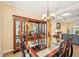Spacious dining room with a glass-top table, display cabinet, and easy access to the living room at 4016 Azurite Way, Bradenton, FL 34211