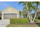 Charming single-story home featuring a well-manicured lawn, mature landscaping, and a brown two-car garage at 4016 Azurite Way, Bradenton, FL 34211