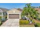 A well-maintained single-story home features a brown two-car garage and mature landscaping at 4016 Azurite Way, Bradenton, FL 34211