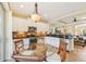 Bright kitchen boasts granite counters, stainless steel appliances and a sunlit breakfast nook with a glass table at 4016 Azurite Way, Bradenton, FL 34211