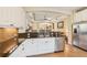 Kitchen features granite counters, stainless appliances and an open layout with views into the dining and living areas at 4016 Azurite Way, Bradenton, FL 34211