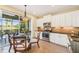 Bright kitchen with stainless steel appliances, a breakfast nook, and a serene outdoor view at 4016 Azurite Way, Bradenton, FL 34211