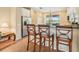 Kitchen bar area with stainless steel appliances, a breakfast bar, and views of the lake at 4016 Azurite Way, Bradenton, FL 34211