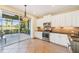Modern kitchen boasting granite countertops, stainless steel appliances, and scenic views through a sliding door at 4016 Azurite Way, Bradenton, FL 34211