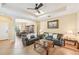 Inviting living room with tile flooring, a ceiling fan, and an open layout to the dining area at 4016 Azurite Way, Bradenton, FL 34211
