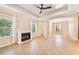 Comfortable living room showcasing a fireplace, tile floors, and tray ceilings at 4016 Azurite Way, Bradenton, FL 34211