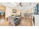 Open-concept living room with tile floors, a fireplace, and a view of the kitchen bar area at 4016 Azurite Way, Bradenton, FL 34211