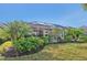 A screened-in patio area surrounded by well-maintained landscaping and mature palm trees provides a tranquil outdoor setting at 4016 Azurite Way, Bradenton, FL 34211