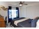 Bedroom with gray wood floors, large windows, and modern ceiling fan at 4111 E 13Th E St, Ellenton, FL 34222