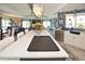 Open-concept kitchen featuring a large island, stylish backsplash, and stainless steel appliances at 4111 E 13Th E St, Ellenton, FL 34222