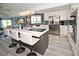 Modern kitchen with white cabinets, stainless steel appliances, island seating, and stylish light fixtures at 4111 E 13Th E St, Ellenton, FL 34222