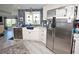 The kitchen features white cabinets, stainless steel refrigerator, and stylish blue subway tile backsplash at 4111 E 13Th E St, Ellenton, FL 34222