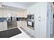 Modern kitchen with stainless steel appliances, white cabinetry, and a functional layout at 4111 E 13Th E St, Ellenton, FL 34222