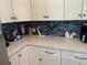 Clean, white kitchen cabinets with modern hardware and a unique blue tiled backsplash at 4111 E 13Th E St, Ellenton, FL 34222