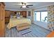 Sunny main bedroom features wood-look flooring, an upholstered bench, and bright, cheerful decor at 4111 E 13Th E St, Ellenton, FL 34222