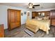 Spacious main bedroom boasts a ceiling fan, wood-look flooring, and a connected en suite bathroom at 4111 E 13Th E St, Ellenton, FL 34222