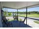 Relaxing covered patio overlooking a serene lake and lush greenery, perfect for outdoor living at 4111 E 13Th E St, Ellenton, FL 34222