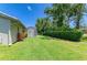 Lush green backyard with a screened-in patio, perfect for outdoor living and relaxation at 4313 Carol Ann Rd # 20, Sarasota, FL 34233