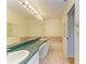 Bathroom with a vanity featuring double sinks, a large mirror, and a bathtub at 4313 Carol Ann Rd # 20, Sarasota, FL 34233