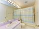 Full bathroom with single vanity, tile floors, and tub with shower at 4313 Carol Ann Rd # 20, Sarasota, FL 34233