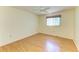 Clean bedroom featuring wood floors, ceiling fan and window with light-filtering shade at 4313 Carol Ann Rd # 20, Sarasota, FL 34233