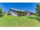 Back yard with screened patio, mature landscaping and beautiful green lawn at 4313 Carol Ann Rd # 20, Sarasota, FL 34233