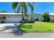 Lush front yard with mature trees and manicured lawn, offering great curb appeal at 4313 Carol Ann Rd # 20, Sarasota, FL 34233